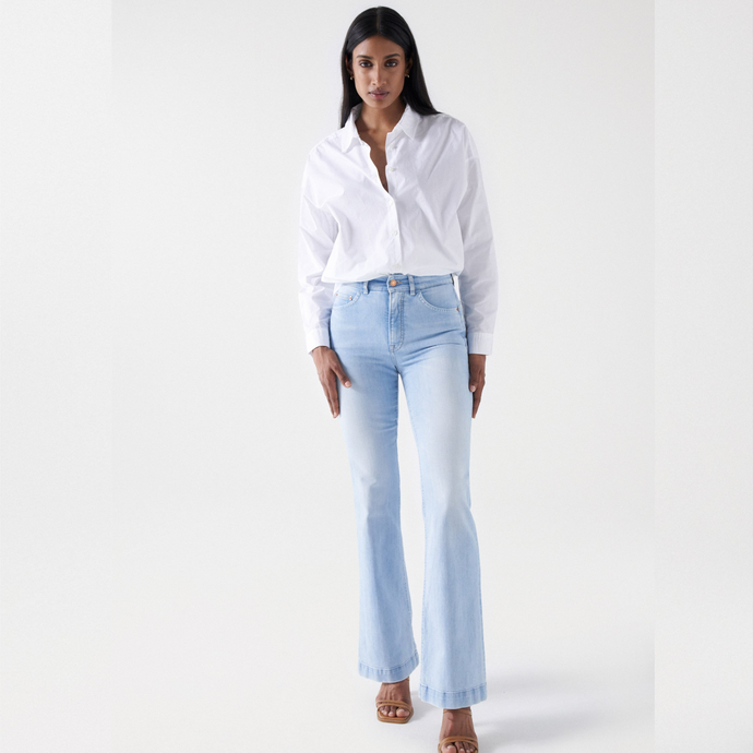 female model looking at camera wearing salsa high rise jeans in blue colour 