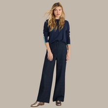 Load image into Gallery viewer, female model wearing white stuff wide leg trousers in navy colour with arms down by side 
