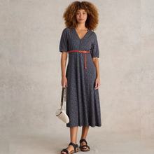 Load image into Gallery viewer, female model wearing whitestuff jeresey dress in navy print with arms down by side
