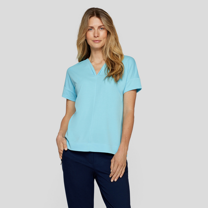 female model looking at camera wearing rabe tshirt in aqua blue colour