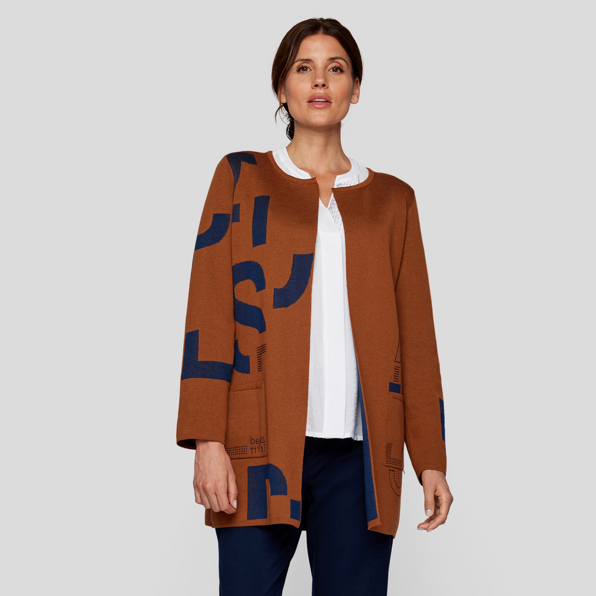 female model wearing rabe cardigan in cognac colour looking at camera