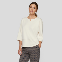 Load image into Gallery viewer, female model wearing rabe top in vanilla colour with hand in pocket
