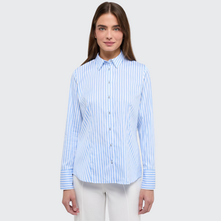 female model looking at camera wearing eterna shirt in blue stripe colour