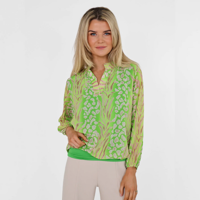 female model looking at camera wearing kate and pippa band top in lime green colour 