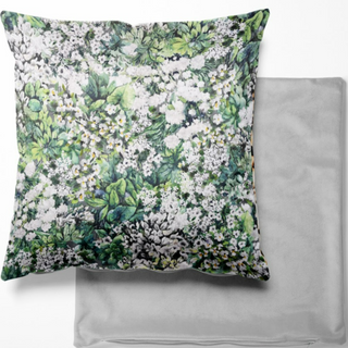 Front face of cushion showing the meadow design with the grey reverse of the cushion 