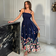 Load image into Gallery viewer, female model wearing girl in mind maxi dress in navy print with hand on table 
