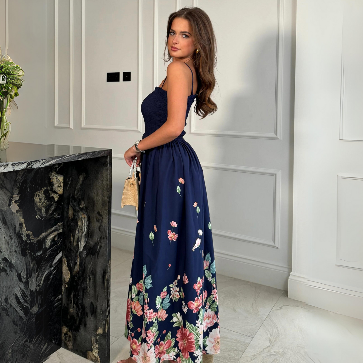 female model looking at camera wearing girl in mind maxi dress in navy print
