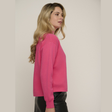 Load image into Gallery viewer, female model looking away from camera wearing rino &amp; pelle jumper in pink colour
