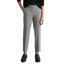 Load image into Gallery viewer, female model with hands in pockets wearing marco polo trousers in black white colours 
