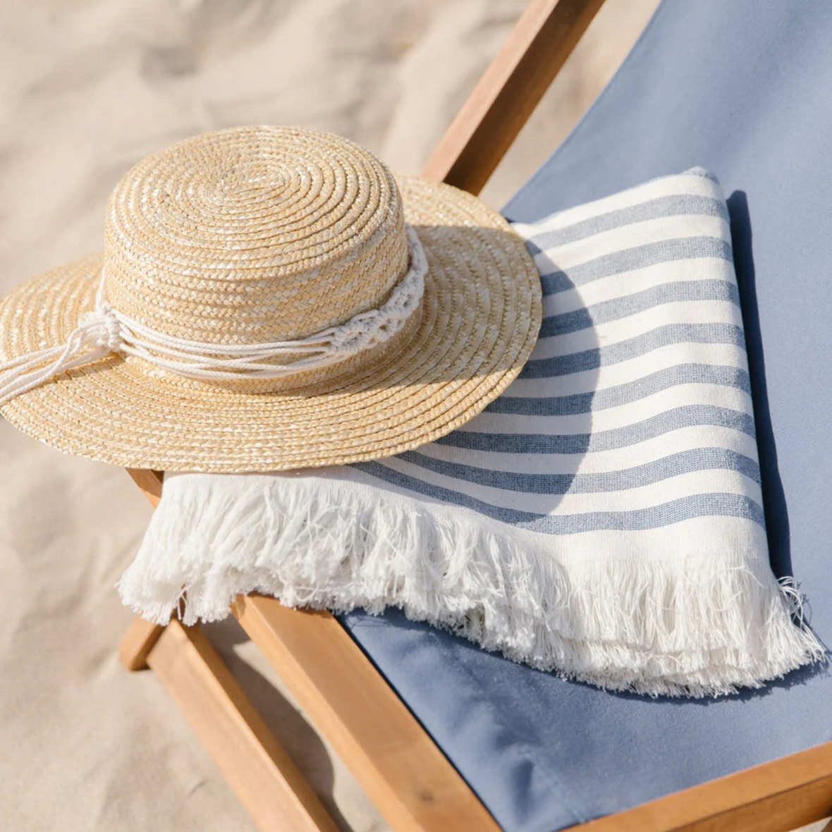 Throw Folded on Deck Chair with Hat 